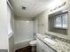 This bathroom features a shower-tub combo and vanity with a granite countertop at 4305 Old Lake Dr, Decatur, GA 30034