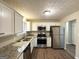Modern kitchen with stainless steel appliances, granite countertops, and white cabinets at 4305 Old Lake Dr, Decatur, GA 30034