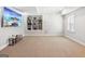 Finished basement offers recessed lights, neutral carpet, display shelving, and a TV at 6410 E Hills Ct, Cumming, GA 30041
