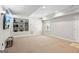 Finished basement with carpet, built-in shelving, recessed lights, and exterior access at 6410 E Hills Ct, Cumming, GA 30041