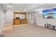 Finished basement features tile flooring, bar with small fridge, and a TV at 6410 E Hills Ct, Cumming, GA 30041