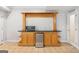 Finished basement wet bar offers granite countertops, a microwave, and wine storage at 6410 E Hills Ct, Cumming, GA 30041