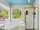 Bright bathroom with a glass enclosed shower and a soaking tub overlooking the backyard at 6410 E Hills Ct, Cumming, GA 30041