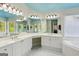 Bright bathroom with double sinks, a glass enclosed shower and a soaking tub at 6410 E Hills Ct, Cumming, GA 30041