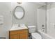 Full bathroom features a shower-tub combo and vanity with wood cabinets at 6410 E Hills Ct, Cumming, GA 30041
