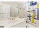 Bathroom features a white vanity, modern fixtures, and a colorful shower curtain over a tub at 6410 E Hills Ct, Cumming, GA 30041