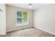 Bright bedroom with a ceiling fan and large window at 6410 E Hills Ct, Cumming, GA 30041