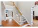 Elegant foyer showcasing a staircase, hardwood floors, and an open view to the living room with fireplace, creating a welcoming ambiance at 6410 E Hills Ct, Cumming, GA 30041