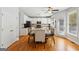 Open kitchen with dining area features wooden table and stainless steel appliances at 6410 E Hills Ct, Cumming, GA 30041