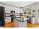 Kitchen features a center island, stainless steel appliances, and white cabinets at 6410 E Hills Ct, Cumming, GA 30041
