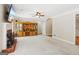 Open living room features a brick fireplace, ceiling fan, and built-in shelving at 6410 E Hills Ct, Cumming, GA 30041