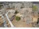 Aerial view of a traditional-style house with a long driveway and mature trees at 50 Red River Ct, Covington, GA 30014