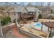 Aerial view of backyard with pool, deck, waterfall feature, pergola, and brick pavers at 50 Red River Ct, Covington, GA 30014