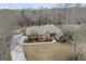 Expansive aerial view of a brick home, showcasing its surrounding landscape and driveway at 50 Red River Ct, Covington, GA 30014