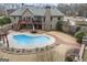 Aerial view of backyard with pool, patio, deck, and outdoor waterfall feature at 50 Red River Ct, Covington, GA 30014
