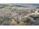 Stunning aerial view of a home on a sprawling lot with a pool and mature trees at 50 Red River Ct, Covington, GA 30014