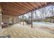 Covered porch with an in-ground pool and furniture for outdoor living at 50 Red River Ct, Covington, GA 30014