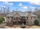 Aerial view of the backyard revealing a multi-level deck, patio, and mature landscaping at 50 Red River Ct, Covington, GA 30014