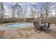 Backyard featuring a large inground pool, beautiful landscaping, and a cozy patio area perfect for outdoor entertainment at 50 Red River Ct, Covington, GA 30014