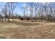 Expansive backyard with mature trees and view of the home at 50 Red River Ct, Covington, GA 30014