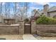 A private pool area enhanced by a pergola and brick privacy wall at 50 Red River Ct, Covington, GA 30014