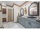Bathroom features dual sinks, granite countertops, matching mirrors, and updated fixtures at 50 Red River Ct, Covington, GA 30014
