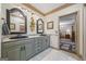 Bathroom with dual sinks, granite countertops, matching mirrors, and access to the bedroom at 50 Red River Ct, Covington, GA 30014