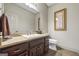 Bathroom featuring a granite vanity with a tile floor, toilet, framed artwork and a towel at 50 Red River Ct, Covington, GA 30014
