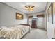 Cozy bedroom features a ceiling fan, neutral walls, and a dresser next to a window with privacy blinds at 50 Red River Ct, Covington, GA 30014