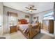 Comfortable bedroom boasts a ceiling fan and a wood bed with plush bedding and coordinating furnishings at 50 Red River Ct, Covington, GA 30014