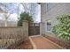 Charming brick wall with a wooden gate, enhancing the property's curb appeal and providing privacy at 50 Red River Ct, Covington, GA 30014