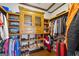 Spacious walk-in closet features custom wooden shelving, wood floors, and ample storage space at 50 Red River Ct, Covington, GA 30014