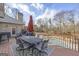 Spacious deck featuring an outdoor dining set with a view of the backyard pool and surrounding trees at 50 Red River Ct, Covington, GA 30014