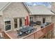 A spacious wooden deck with outdoor seating and an umbrella for a perfect outdoor gathering at 50 Red River Ct, Covington, GA 30014