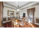 Traditional dining room with chandelier lighting and a large window at 50 Red River Ct, Covington, GA 30014