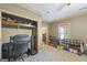 Functional exercise area with ample storage, weights, and a view into an adjacent room, perfect for a home gym at 50 Red River Ct, Covington, GA 30014