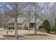 Exterior view of home showcasing landscaping and mature trees in the front yard at 50 Red River Ct, Covington, GA 30014