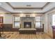 A cozy room featuring a stone fireplace and wood-trimmed windows creating a warm and inviting ambiance at 50 Red River Ct, Covington, GA 30014