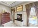 Cozy fireplace with mantle flanked by windows in main bedroom with beautiful natural light and outside view of pool at 50 Red River Ct, Covington, GA 30014