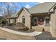 Brick home featuring a covered front porch with seating and arched windows at 50 Red River Ct, Covington, GA 30014