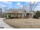 A well-maintained brick house with manicured landscaping and lush green trees at 50 Red River Ct, Covington, GA 30014