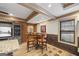 Cozy game room with a round table, leather chairs, exposed beams and a brick accent wall at 50 Red River Ct, Covington, GA 30014