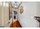 Hallway leads to the laundry room with hardwood floors, custom lighting, and elegant wall decor at 50 Red River Ct, Covington, GA 30014