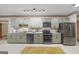 Contemporary kitchen featuring stainless steel appliances, granite countertops and stylish light-green cabinetry at 50 Red River Ct, Covington, GA 30014