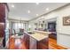 Open concept kitchen with hardwood floors and seamless transition to dining and living areas at 50 Red River Ct, Covington, GA 30014