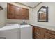 Laundry room with granite counter, washer, dryer, and storage cabinets at 50 Red River Ct, Covington, GA 30014