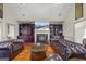 Inviting living room with fireplace and built-ins, featuring hardwood floors and leather seating at 50 Red River Ct, Covington, GA 30014