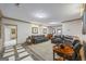 Spacious living room featuring leather sofas and custom wood flooring at 50 Red River Ct, Covington, GA 30014