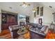 Vaulted living room includes hardwood floors, built-in shelving, and a fireplace with comfortable leather sofas at 50 Red River Ct, Covington, GA 30014