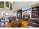 Elegant living room showcasing a fireplace, built-in shelving, and hardwood floors at 50 Red River Ct, Covington, GA 30014